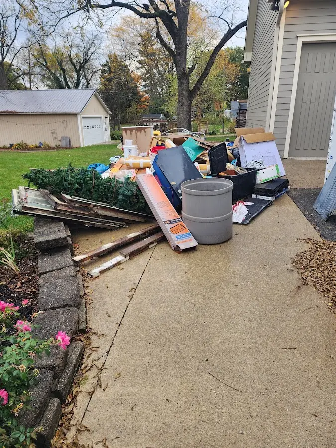 Dumpster being loaded with debris for Roofing Dumpster Rental in McKinney